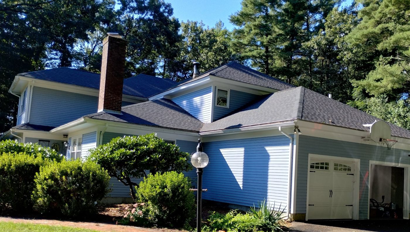 A house with a new roof is beautiful from all sides.