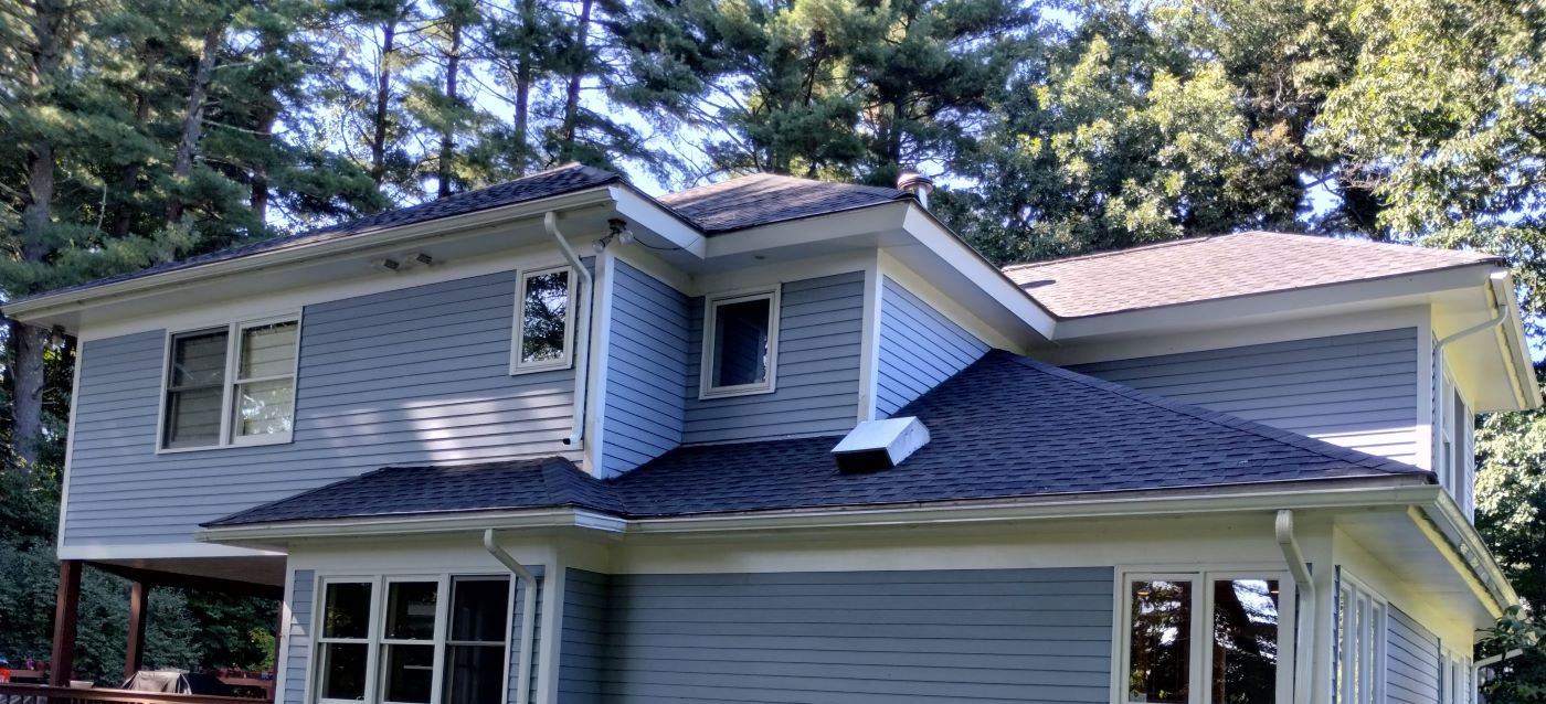 A house with a new roof is beautiful from all sides.